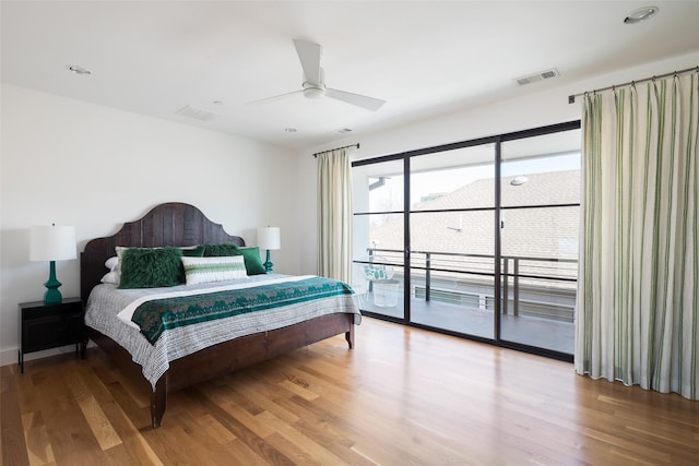 bedroom featuring light wood-type flooring, visible vents, and access to exterior