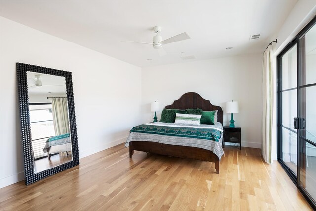 bedroom featuring visible vents, baseboards, and light wood-style floors