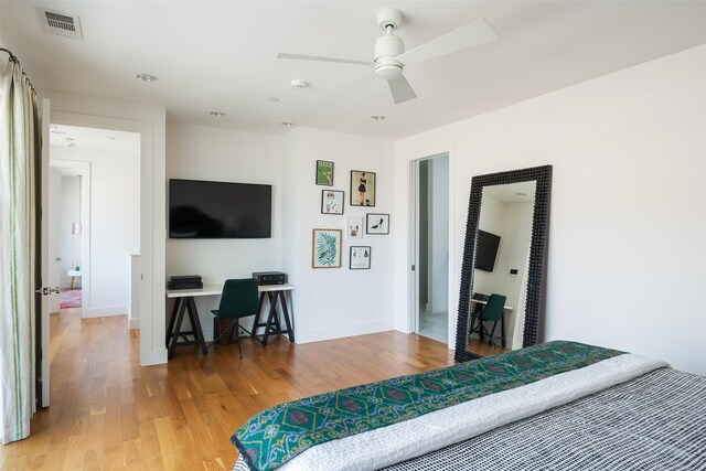 bedroom with visible vents, baseboards, a ceiling fan, and light wood finished floors