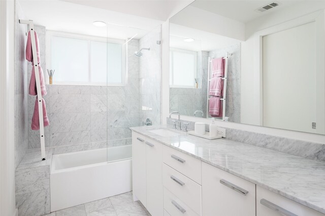 full bath featuring vanity, tub / shower combination, visible vents, and marble finish floor