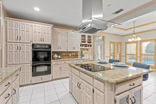 kitchen featuring black appliances, island exhaust hood, visible vents, and crown molding