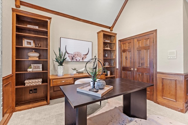 home office with light carpet, a wainscoted wall, lofted ceiling, and crown molding