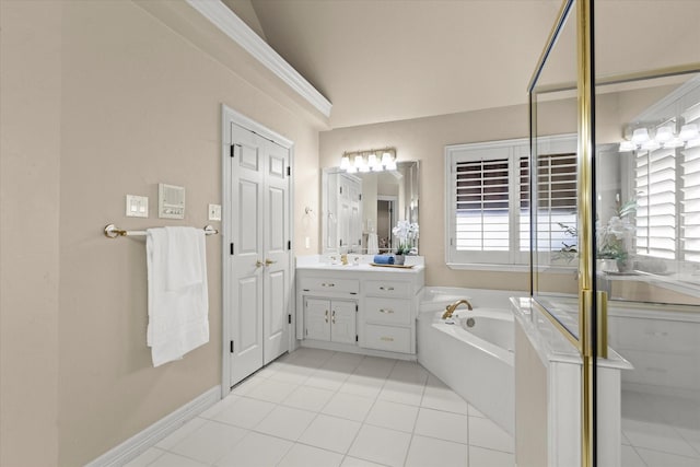 bathroom with a wealth of natural light, a garden tub, vanity, and tile patterned floors