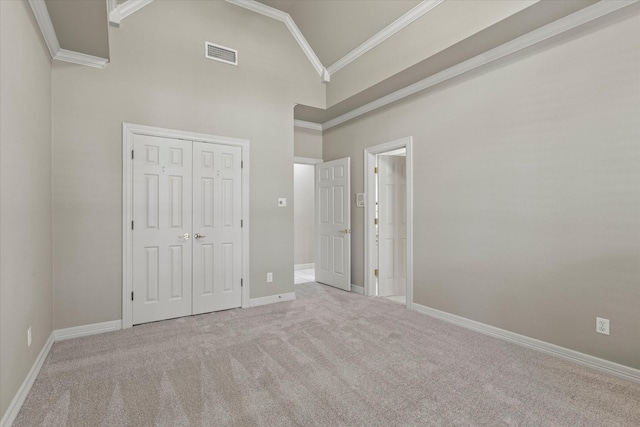 unfurnished bedroom with carpet floors, baseboards, visible vents, and crown molding