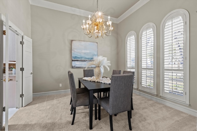 carpeted dining space with a chandelier, ornamental molding, plenty of natural light, and baseboards