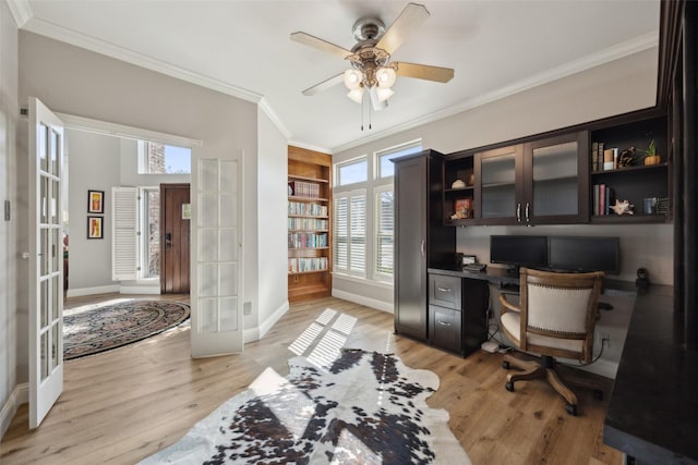 home office with baseboards, french doors, light wood-style flooring, and crown molding