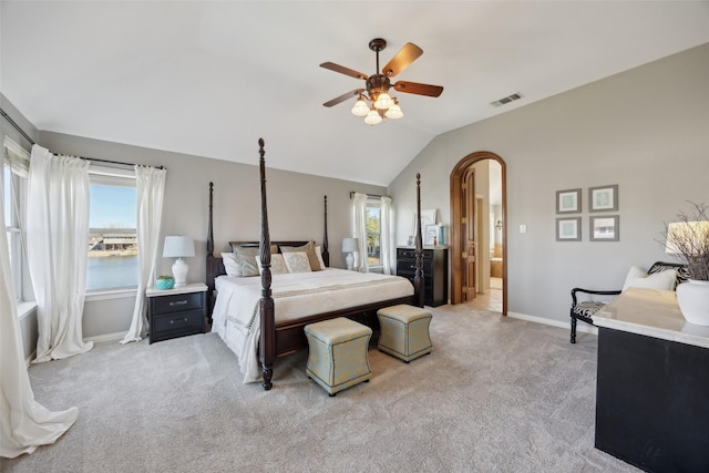 bedroom featuring light carpet, vaulted ceiling, visible vents, and baseboards