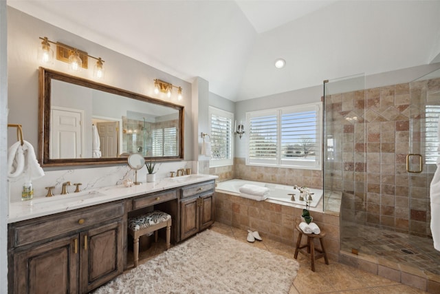 full bathroom with a garden tub, tile patterned flooring, a sink, vaulted ceiling, and a shower stall