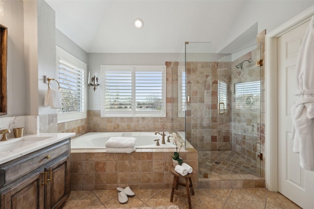 bathroom with lofted ceiling, a shower stall, vanity, and a bath