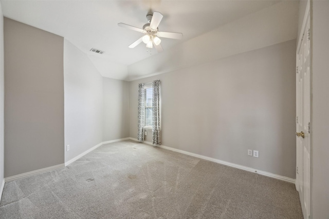 carpeted empty room featuring ceiling fan, visible vents, and baseboards