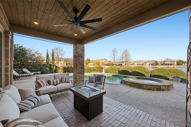 view of patio / terrace featuring ceiling fan, an outdoor living space with a fire pit, and a pool with connected hot tub