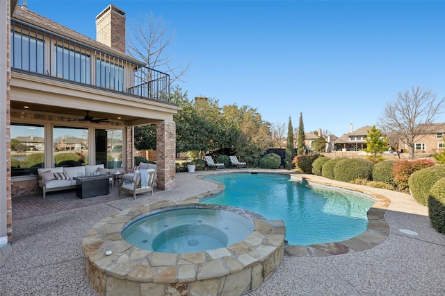 view of swimming pool with a patio area, a pool with connected hot tub, outdoor lounge area, and a ceiling fan