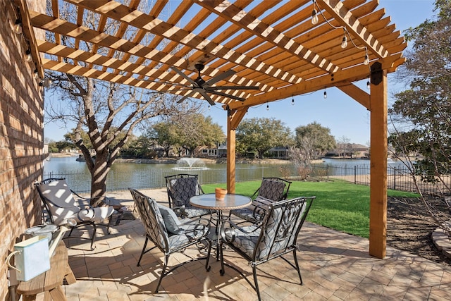 view of patio / terrace with ceiling fan, a water view, fence, and a pergola