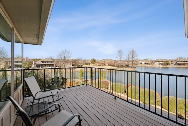 balcony with a water view and a residential view