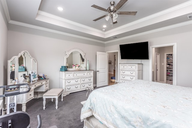 bedroom featuring visible vents, a tray ceiling, crown molding, carpet flooring, and recessed lighting