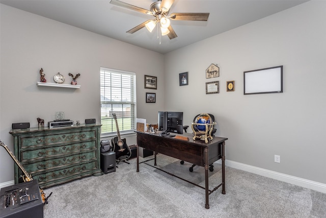 carpeted home office with a ceiling fan and baseboards