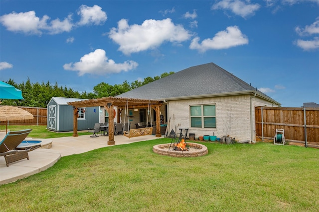 back of property featuring brick siding, an outdoor fire pit, a patio area, a pergola, and a fenced backyard