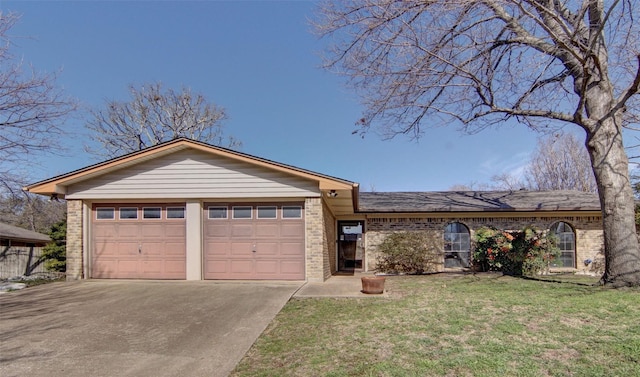 ranch-style home featuring concrete driveway, brick siding, an attached garage, and a front lawn