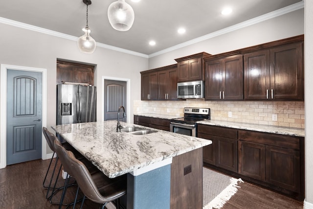 kitchen with dark wood finished floors, stainless steel appliances, backsplash, a sink, and dark brown cabinetry