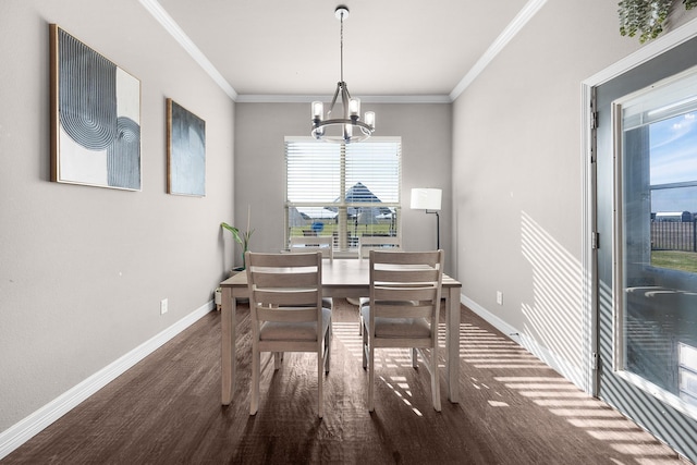 dining space featuring crown molding, baseboards, and an inviting chandelier