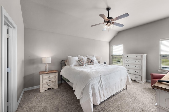 bedroom featuring lofted ceiling, baseboards, a ceiling fan, and light colored carpet