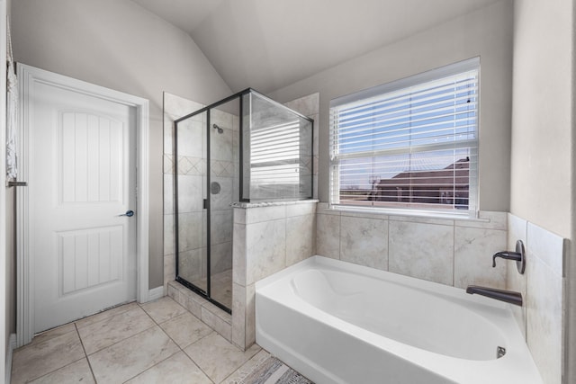 full bath with lofted ceiling, a stall shower, a bath, and tile patterned floors