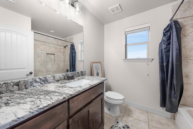 bathroom featuring visible vents, toilet, vanity, tile patterned flooring, and baseboards