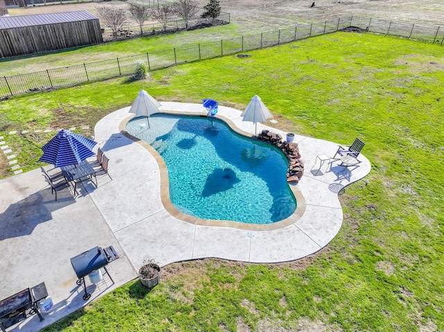 view of pool featuring a fenced in pool, a patio area, a lawn, and a fenced backyard