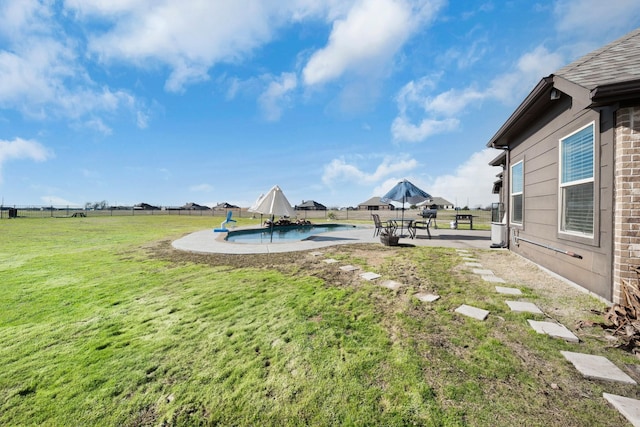 view of yard with a fenced backyard, a fenced in pool, and a patio