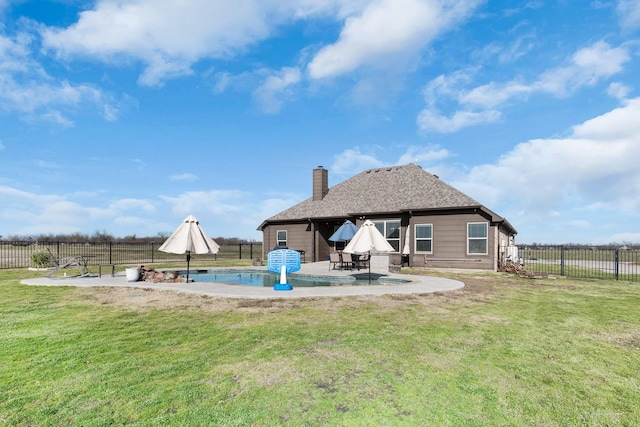 back of house featuring a lawn, a patio area, and fence