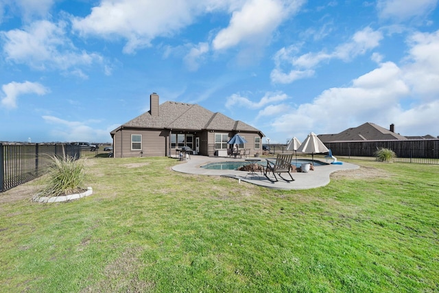 rear view of property with a fenced backyard, a patio, and a lawn