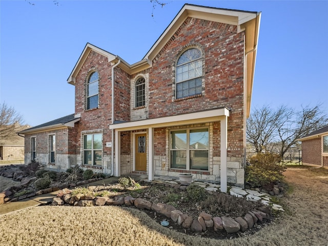 traditional home with stone siding and brick siding