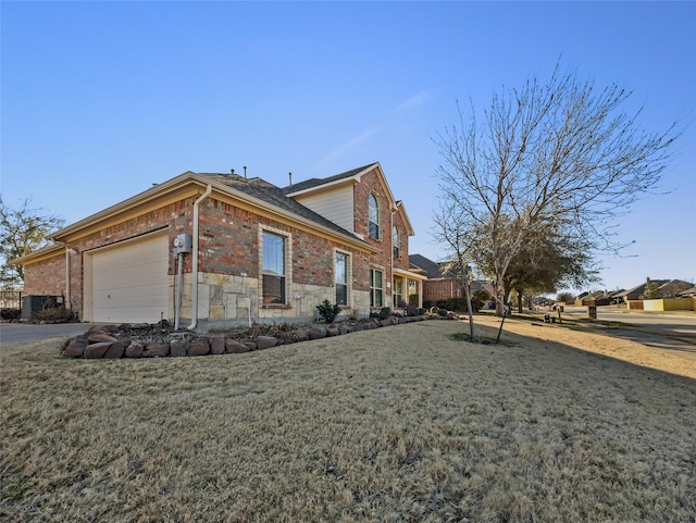 view of side of property featuring an attached garage, a yard, driveway, and brick siding