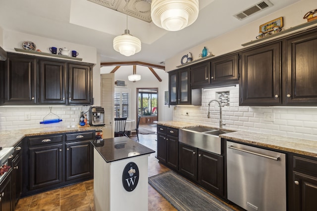 kitchen with light stone counters, a sink, visible vents, stainless steel dishwasher, and backsplash