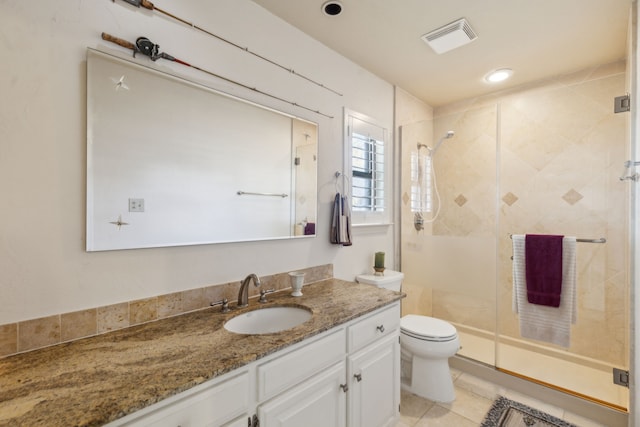 bathroom with visible vents, toilet, vanity, a shower stall, and tile patterned floors