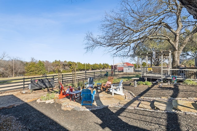 view of yard featuring a patio, fence, and a wooden deck