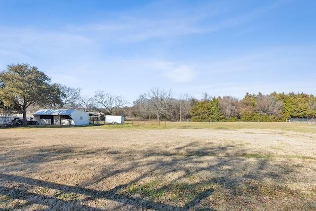 view of yard with fence and an outdoor structure