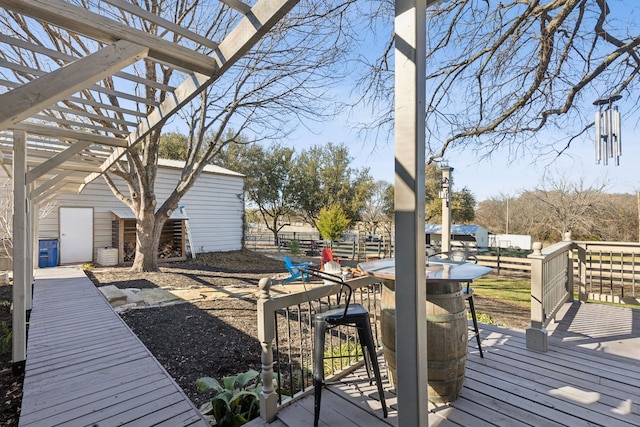 wooden deck featuring fence and a pergola