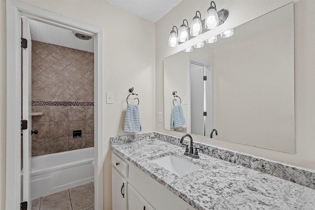 full bath with tile patterned flooring, shower / bathing tub combination, a textured ceiling, and vanity