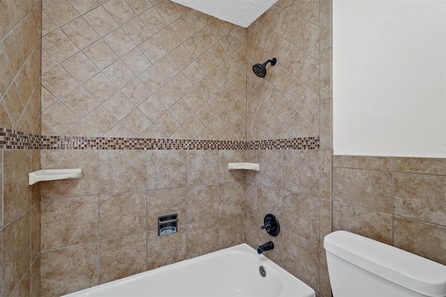 bathroom with shower / tub combination, tile walls, and toilet