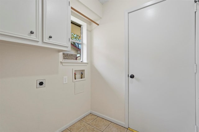 laundry area featuring washer hookup, cabinet space, light tile patterned flooring, electric dryer hookup, and baseboards