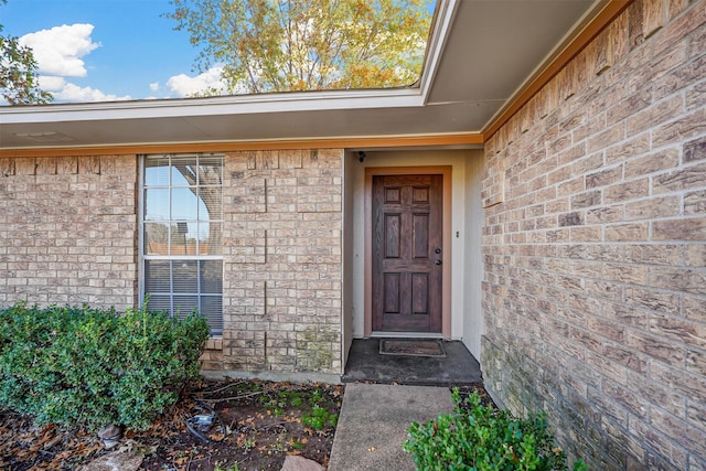 property entrance featuring brick siding