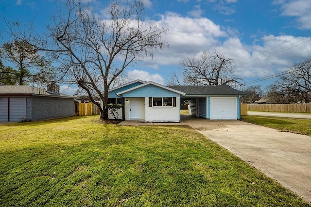 view of front of home featuring driveway, an attached garage, fence, and a front yard