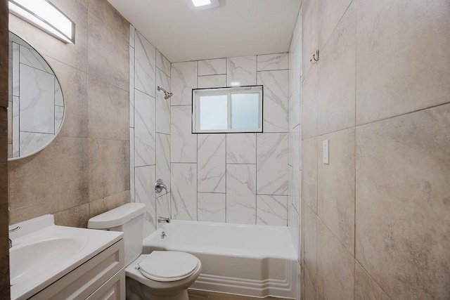 full bathroom featuring bathtub / shower combination, tile walls, toilet, and vanity