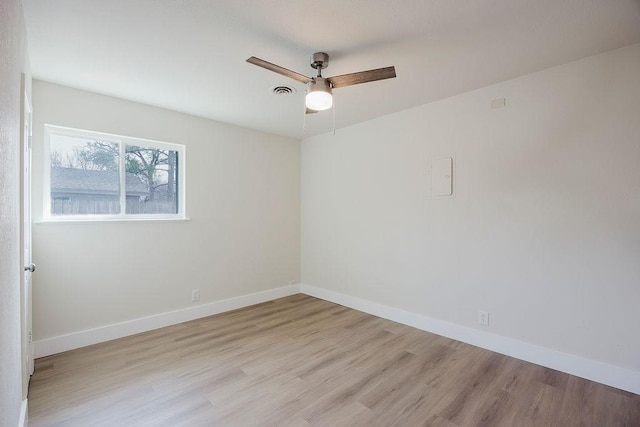 empty room featuring light wood-type flooring, ceiling fan, and baseboards