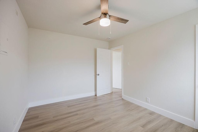 unfurnished room with light wood-style floors, baseboards, and a ceiling fan