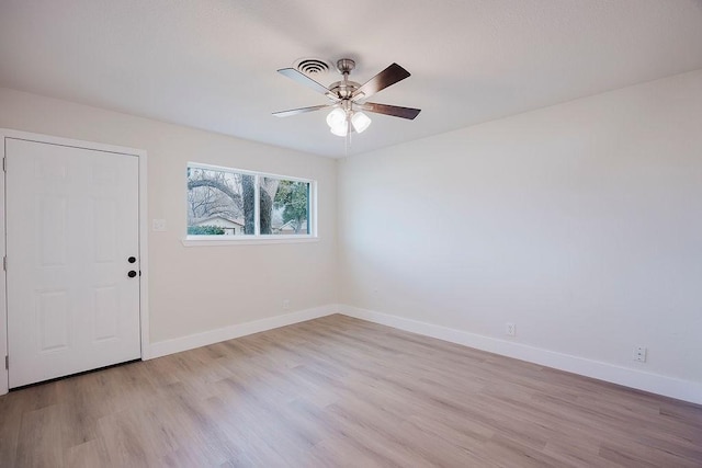 spare room with ceiling fan, baseboards, and wood finished floors