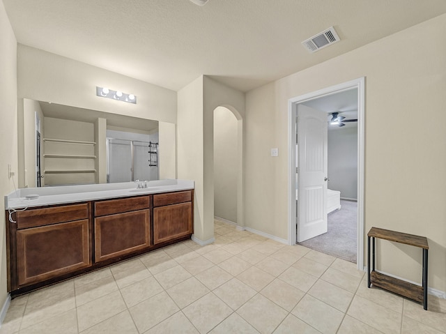 bathroom featuring a stall shower, visible vents, baseboards, tile patterned flooring, and vanity