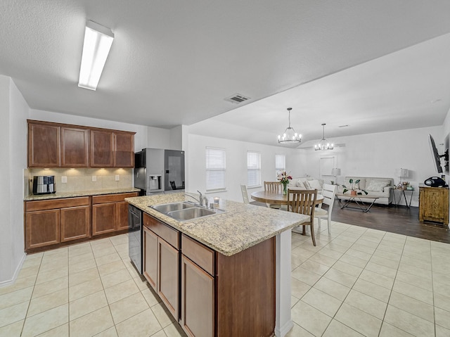 kitchen featuring dishwasher, a sink, stainless steel fridge with ice dispenser, and light tile patterned floors