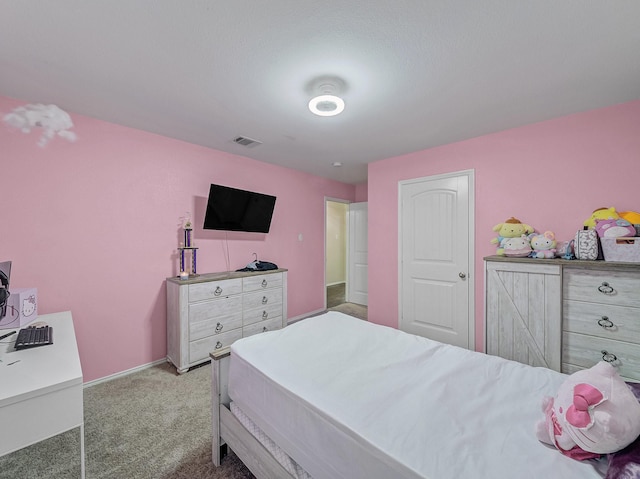 carpeted bedroom with visible vents and baseboards